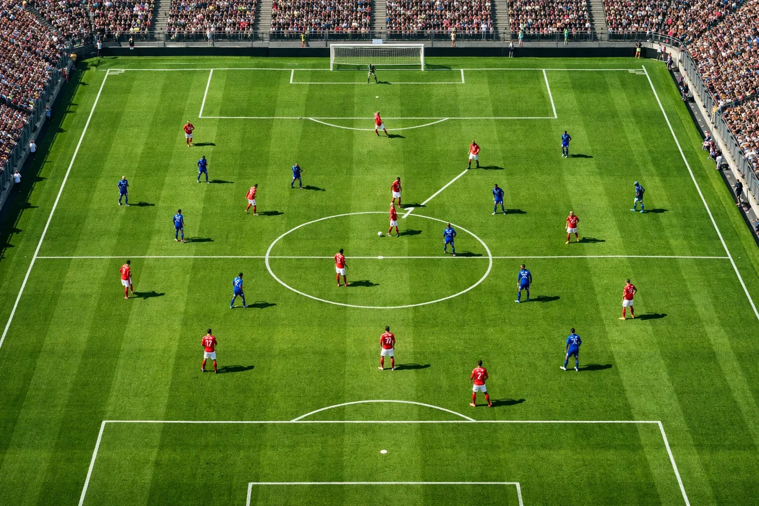 Campo di calcio visto dall'alto con giocatori in posizione durante una partita